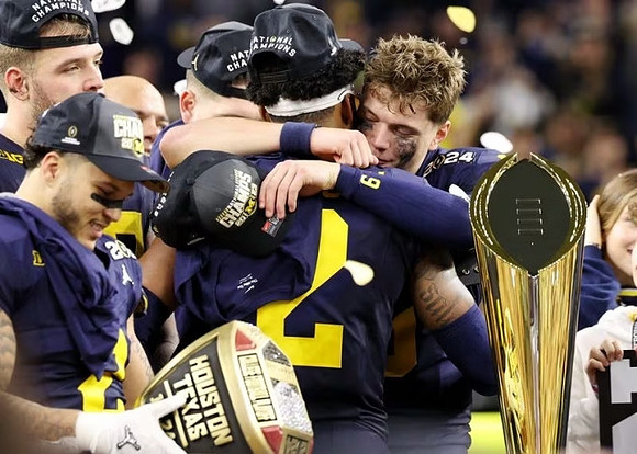 Blake Corum (2), Zak Zinter (65), Will Johnson (2), J.J. McCarthy (9), and National Championship Trophy