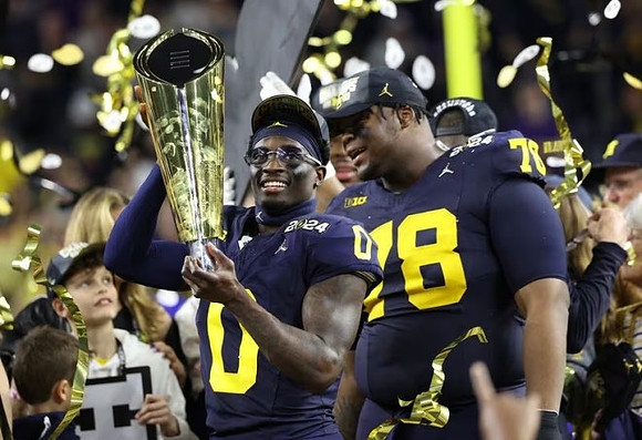Mike Sainristil (0), Kenneth Grant (78), and National Championship Trophy