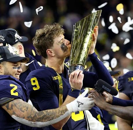 Blake Corum (2), J.J. McCarthy (9), and National Championship Trophy