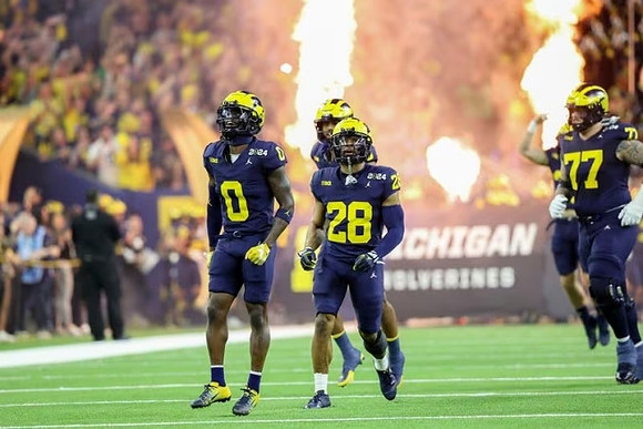 Mike Sainristil (0), Quinten Johnson (28), and Trevor Keegan (77)