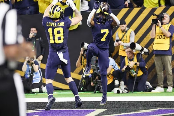 Colston Loveland (18) and Donovan Edwards (7)