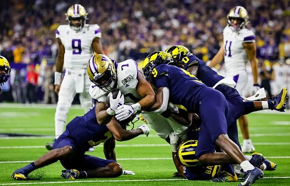 Makari Paige (7), Rod Moore (9), Michael Barrett (23), and Mike Sainristil (0)