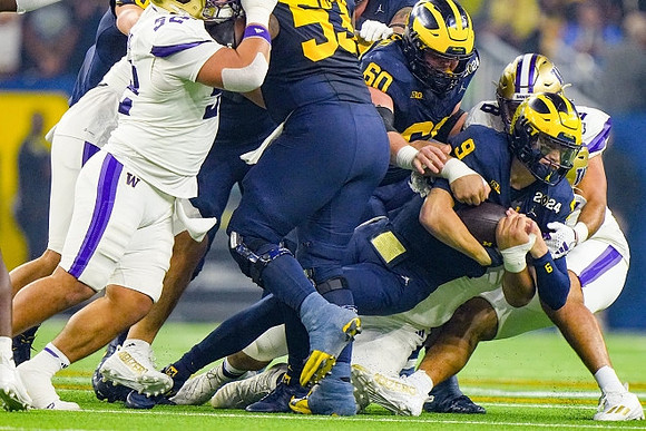 Trente Jones (53), Drake Nugent (60), and J.J. McCarthy (9)