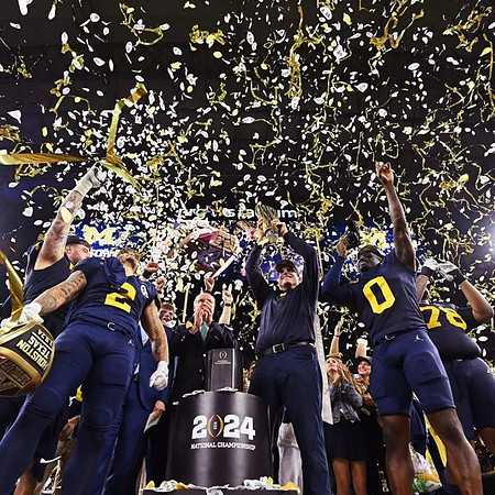 Trevor Keegan (77), Blake Corum (2), Jim Harbaugh, Mike Sainristil (0), Kenneth Grant (78), and National Championship Trophy