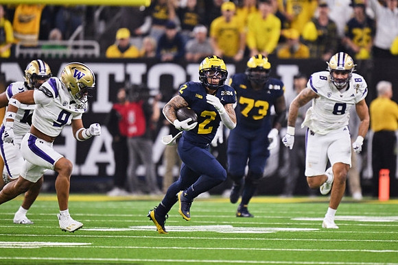 Blake Corum (2) and LaDarius Henderson (73)