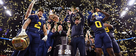 Blake Corum (2), Jim Harbaugh, Mike Sainristil (0), and National Championship Trophy