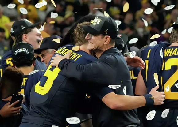 J.J. McCarthy (9) and Jim Harbaugh