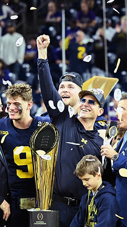 J.J. McCarthy (9), Zak Zinter (65), Jim Harbaugh, and National Championship Trophy