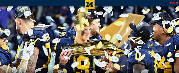Trevor Keegan (77), J.J. McCarthy (9), Zak Zinter (65), Mike Sainristil (0), Kris Jenkins (94), and National Championship Trophy