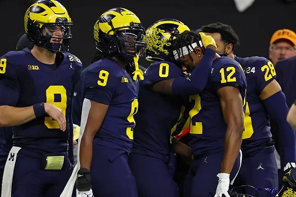 J.J. McCarthy (9), Rod Moore (9), Mike Sainristil (0), Josh Wallace (12), and Quinten Johnson (28)