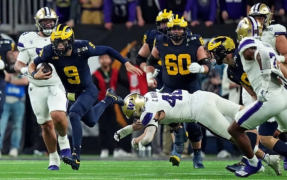 J.J. McCarthy (9) and Drake Nugent (60)