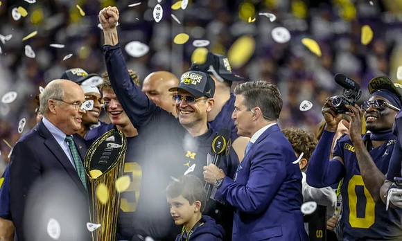 Will Johnson (2), J.J. McCarthy (9), Jim Harbaugh, Mike Sainristil (0), and National Championship Trophy