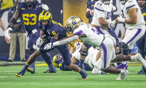 Trente Jones (53), Cornelius Johnson (6), and J.J. McCarthy (9)
