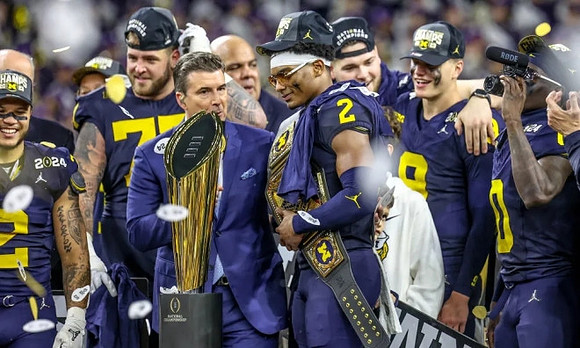 Blake Corum (2), Trevor Keegan (77), Will Johnson (2), Zak Zinter (65), J.J. McCarthy (9), Mike Sainristil (0), and National Championship Trophy