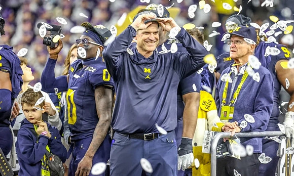 Mike Sainristil (0), Jim Harbaugh, and Jack Harbaugh