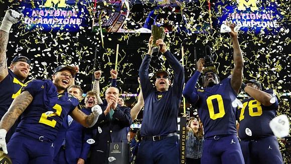 Trevor Keegan (77), Blake Corum (2), J.J. McCarthy (9), Jim Harbaugh, Mike Sainristil (0), Alessandro Lorenzetti (89), and National Championship Trophy