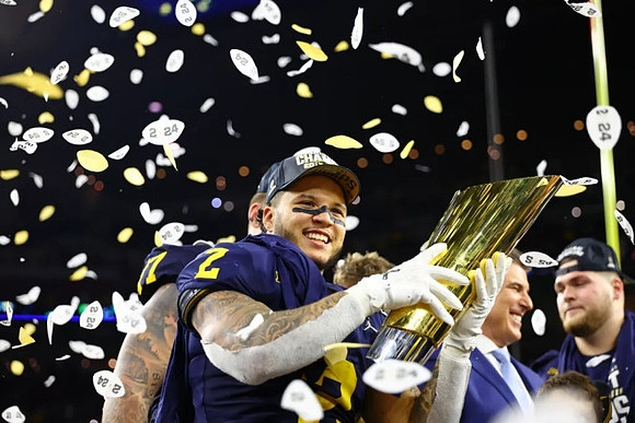 Blake Corum (2), Zak Zinter (65), and National Championship Trophy