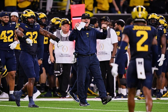 Jim Harbaugh, Will Johnson (2), Jaylen Harrell (32), and Michigan Team