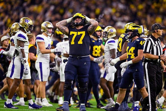 Trevor Keegan (77) and Michigan Team
