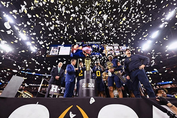 Blake Corum (2), Mike Sainristil (0), Will Johnson (2), Jim Harbaugh, and National Championship Trophy