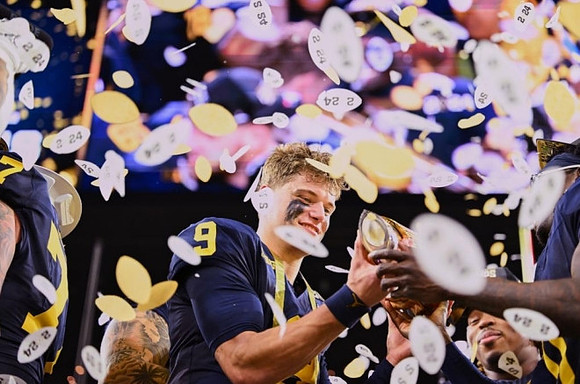 J.J. McCarthy (9) and National Championship Trophy