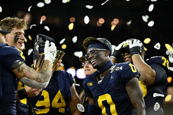 J.J. McCarthy (9), National Championship Trophy, Mike Sainristil (0), Kris Jenkins (94), and Kenneth Grant (78)