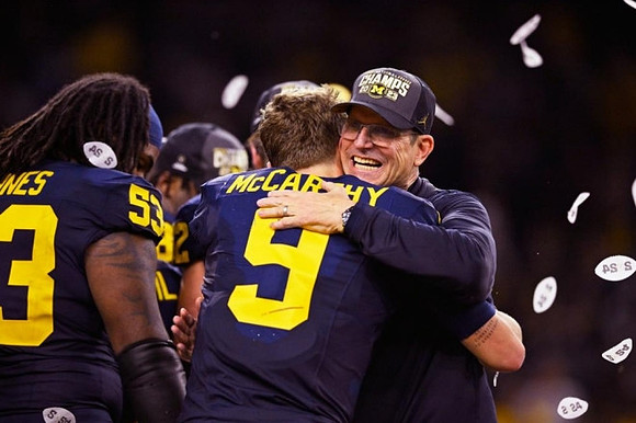 Trente Jones (53), J.J. McCarthy (9), and Jim Harbaugh