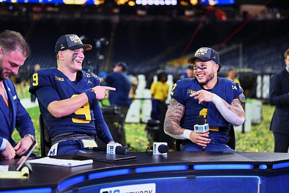 Jake Butt, J.J. McCarthy (9), and Blake Corum (2)