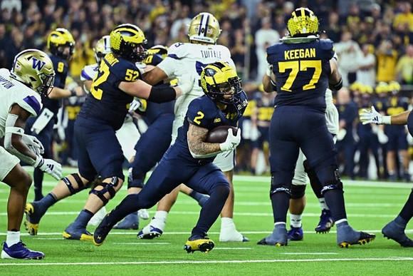J.J. McCarthy (9), Karsen Barnhart (52), Blake Corum (2), and Trevor Keegan (77)