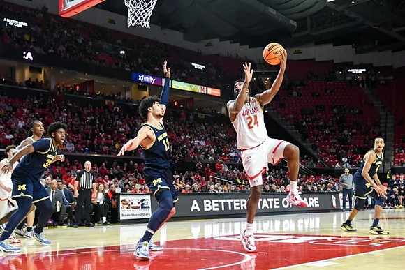 Tarris Reed Jr. (32), Olivier Nkamhoua (13), and Nimari Burnett (4)