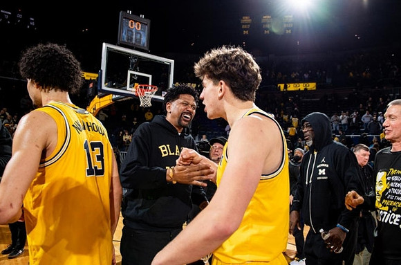 Olivier Nkamhoua (13), Jalen Rose, Will Tschetter (42), and Ray Jackson
