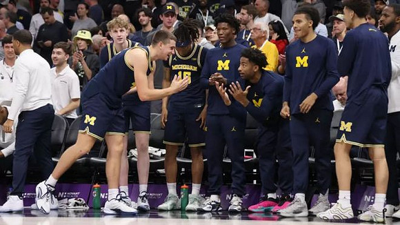 Will Tschetter (42) and Michigan Team