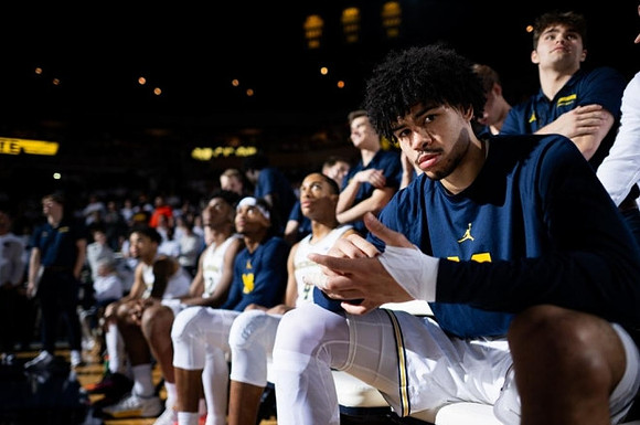 Olivier Nkamhoua (13) and Michigan Team