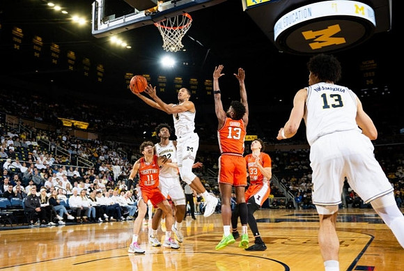 Tarris Reed Jr. (32), Nimari Burnett (4), and Olivier Nkamhoua (13)