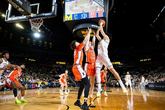 Tarris Reed Jr. (32), Olivier Nkamhoua (13), and Dug McDaniel (0)