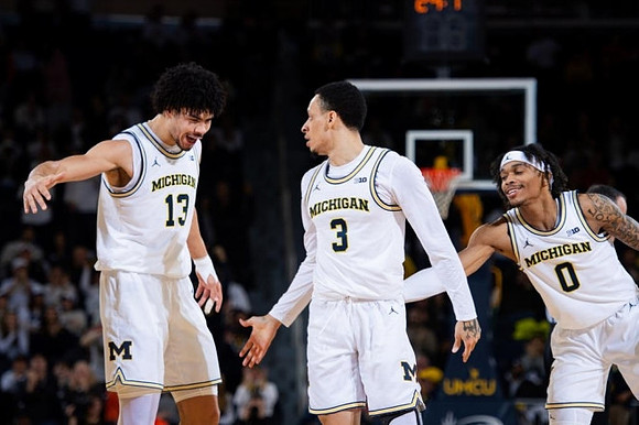 Olivier Nkamhoua (13), Jaelin Llewellyn (3), and Dug McDaniel (0)