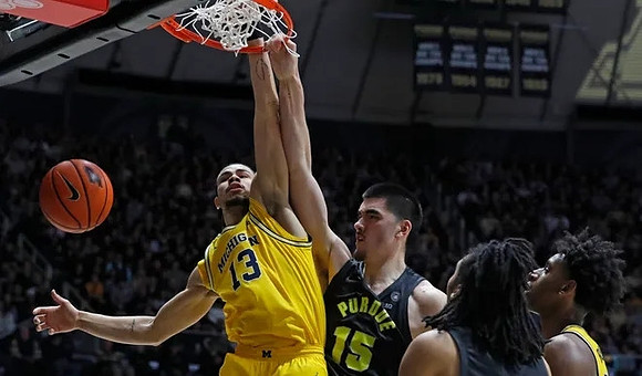 Olivier Nkamhoua (13) and Tarris Reed Jr. (32)