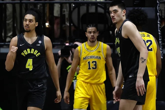 Olivier Nkamhoua (13) and Tarris Reed Jr. (32)