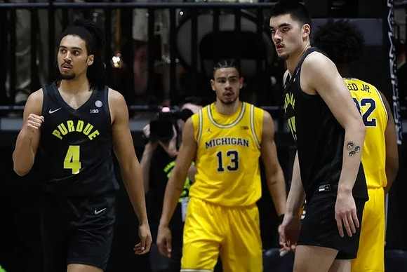 Olivier Nkamhoua (13) and Tarris Reed Jr. (32)