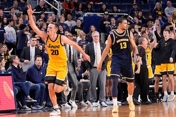 Olivier Nkamhoua (13) and Iowa Head Coach Fran McCaffery
