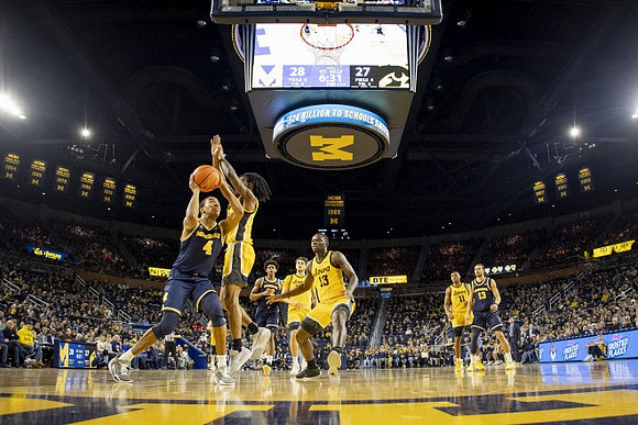 Nimari Burnett (4), Tarris Reed Jr. (32), and Olivier Nkamhoua (13)
