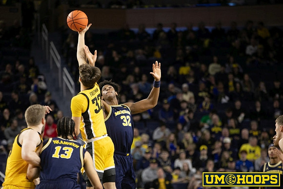 Olivier Nkamhoua (13) and Tarris Reed Jr. (32)