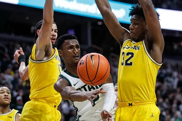 Nimari Burnett (4), Olivier Nkamhoua (13), and Tarris Reed Jr. (32)