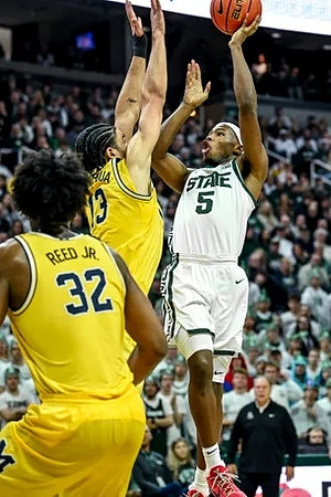 Tarris Reed Jr. (32) and Olivier Nkamhoua (13)