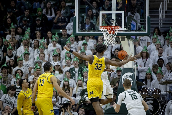Jaelin Llewellyn (3), Olivier Nkamhoua (13), and Tarris Reed Jr. (32)