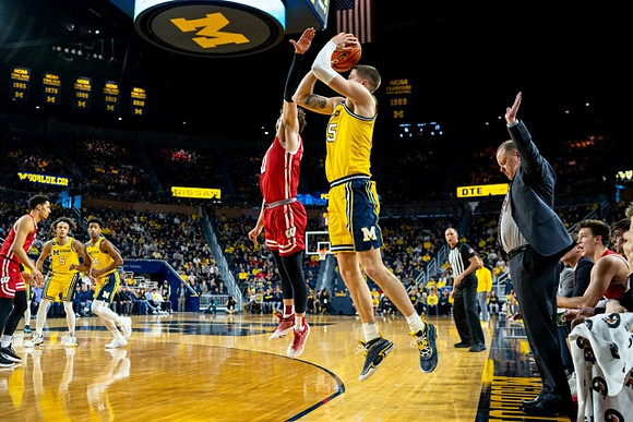 Joey Baker (15), Wisconsin Head Coach Greg Gard, Terrance Williams II (5), and Jace Howard (25)