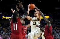 Olivier Nkamhoua (13) and Tarris Reed Jr. (32)