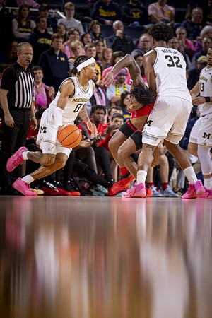 Dug McDaniel (0), Tarris Reed Jr. (32), and Olivier Nkamhoua (13)