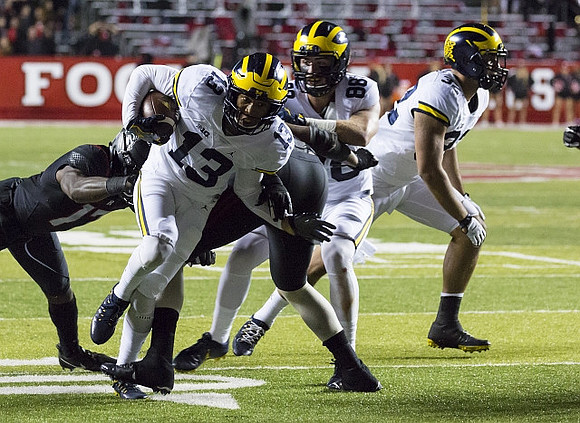 Eddie McDoom (13), Jake Butt (88), and Ty Isaac (32)
