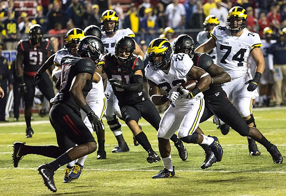 Karan Higdon (22) and Ben Bredeson (74)